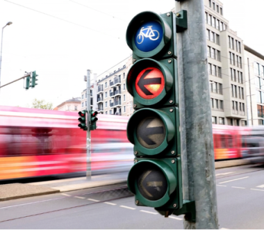 Ampel mit Fahrradsymbol zeigt Rot, Straßenbahn fährt im Hintergrund vorbei. (Bild: DVR/Daniela Stanek)